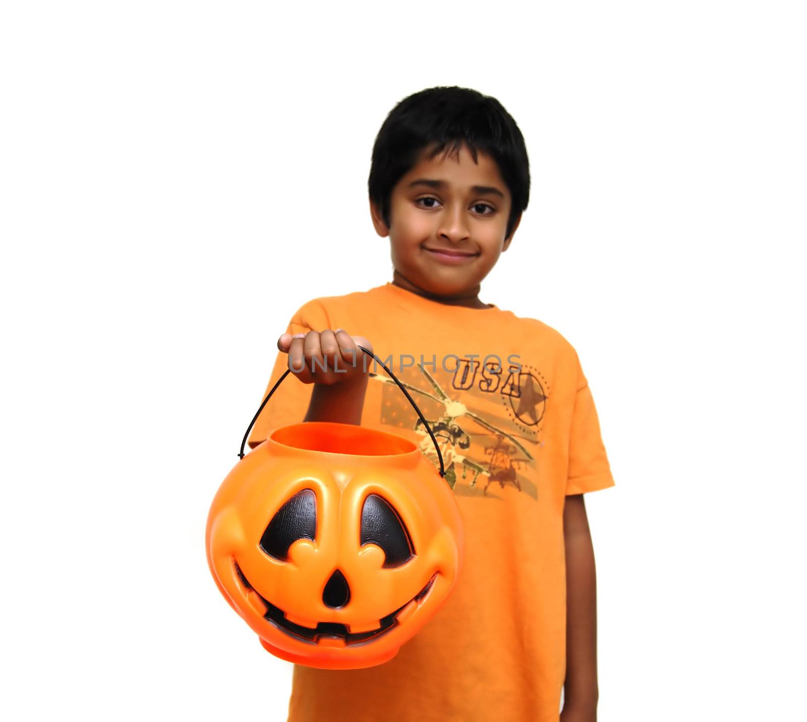 An handsome Indian child holding a candy cart for trick or treat