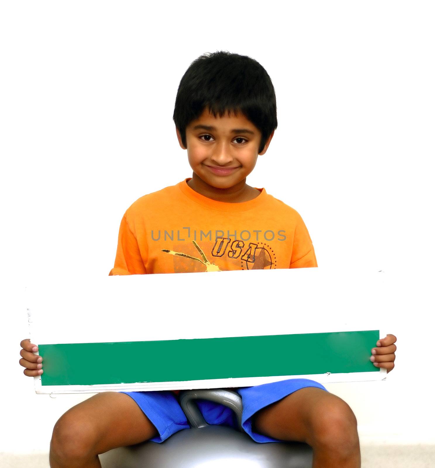 An handsome Indian kid holding a sign board