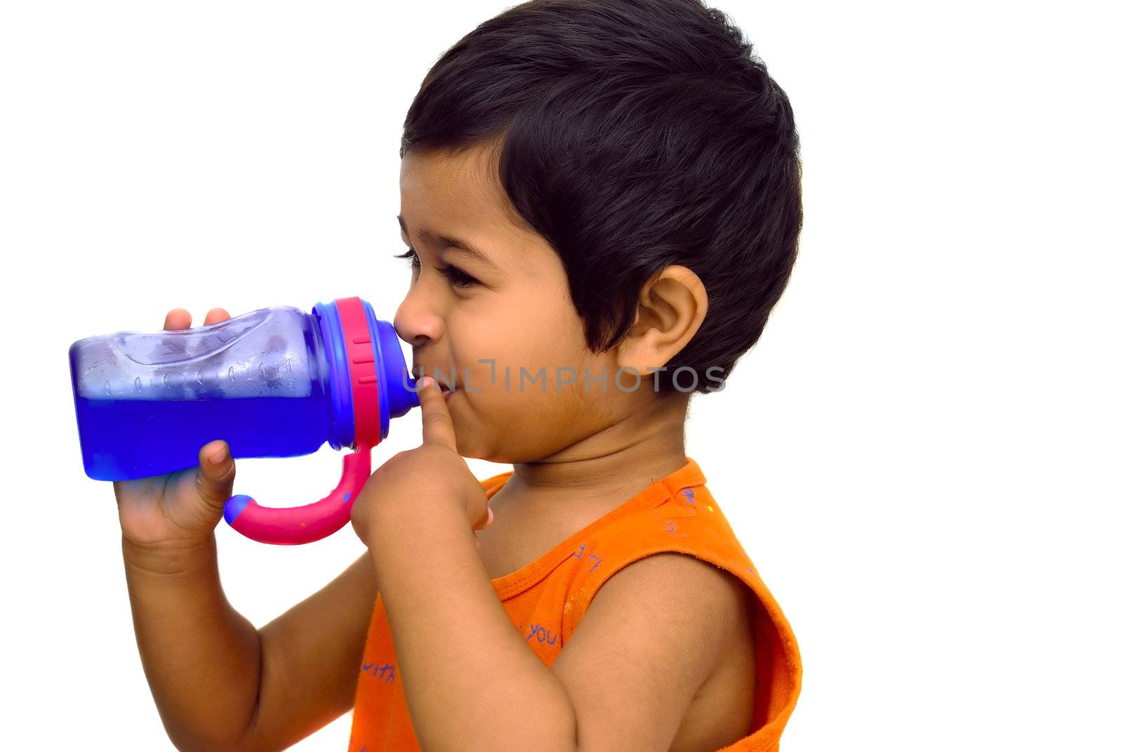 An handsome indian kid having fun drinking juice