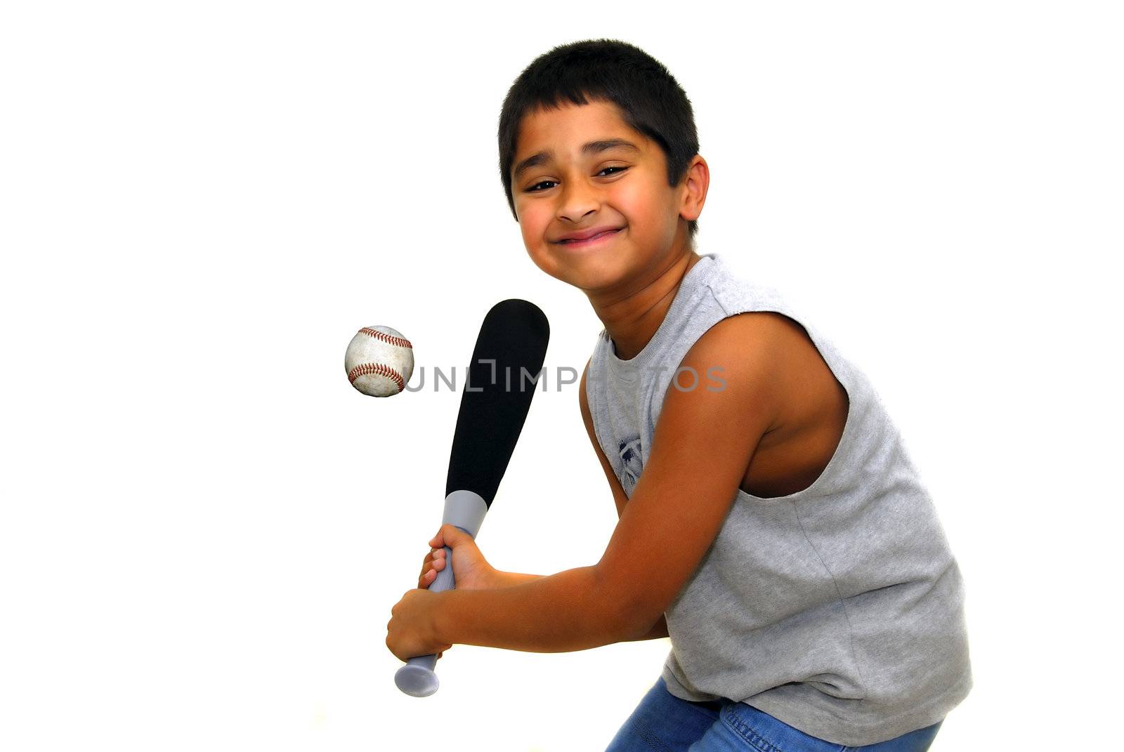 Young handsome indian kid having fun hitting ball