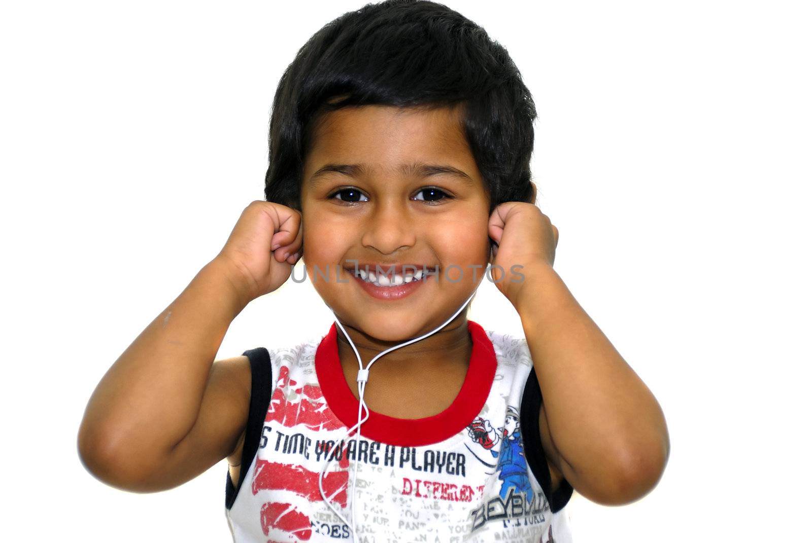 An handsome indian kid having fun listening to music 