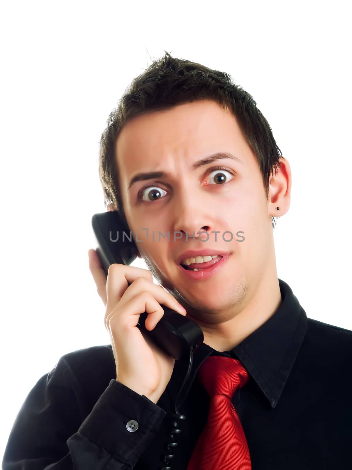 Amazed young man having a phone call