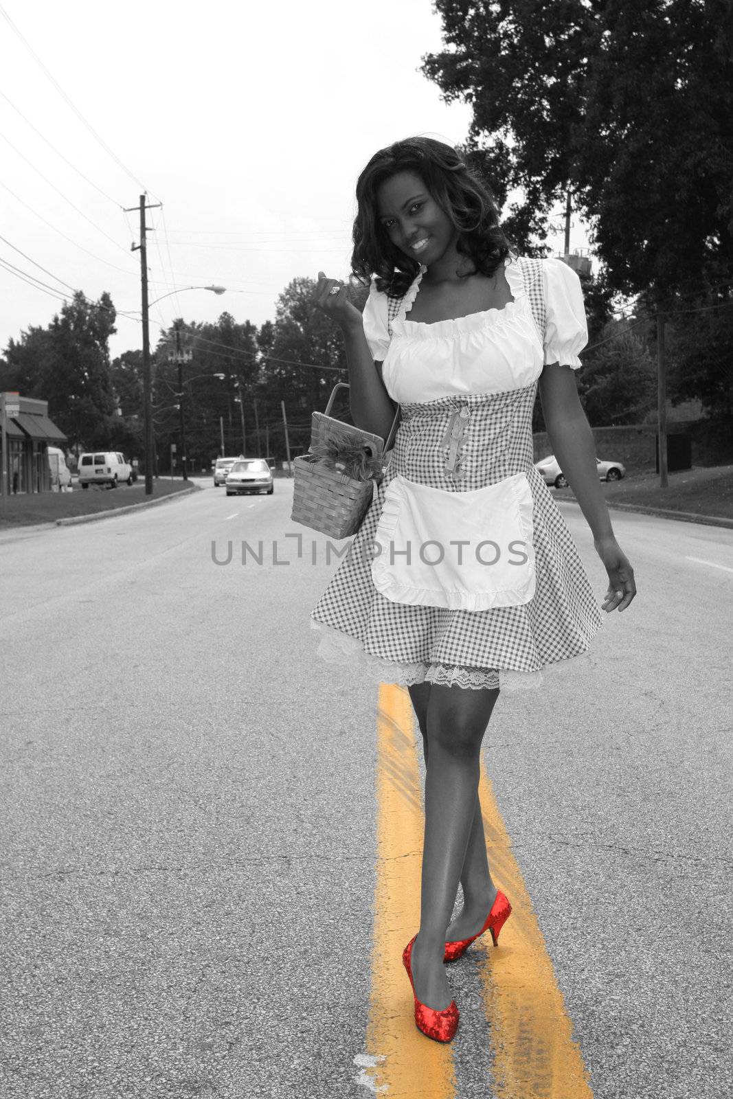 Modern day Dorothy walking down the yellow lined road