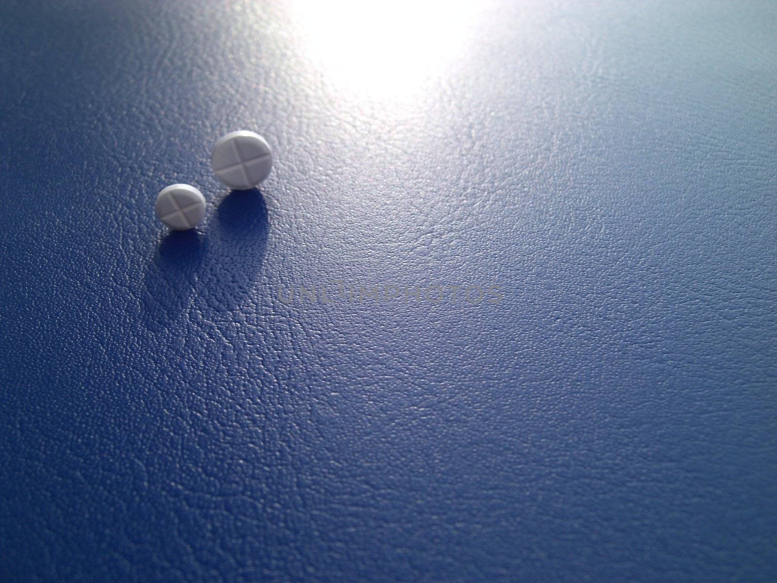 two pills against blue background