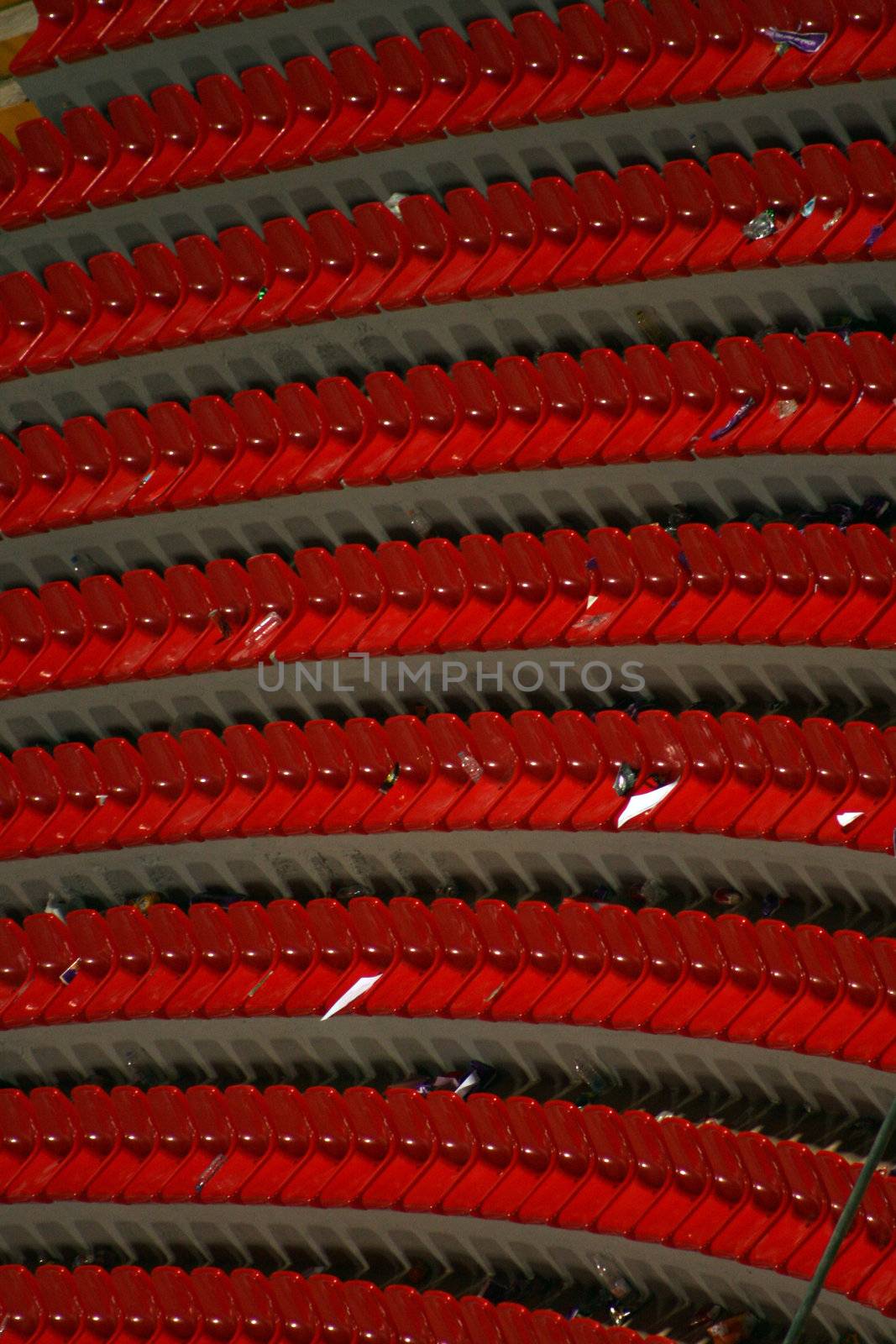 rows of red empty seats in a stadium