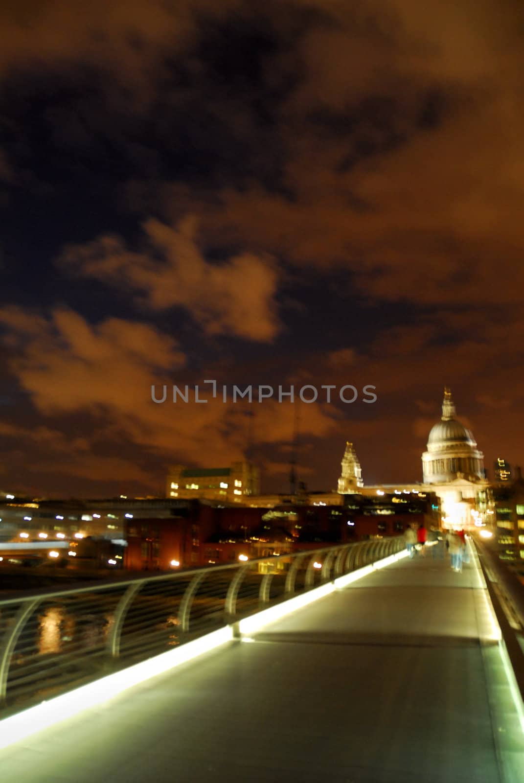 Night sky over London. St Paul cathedral in the background. Lights of millennium bridge.