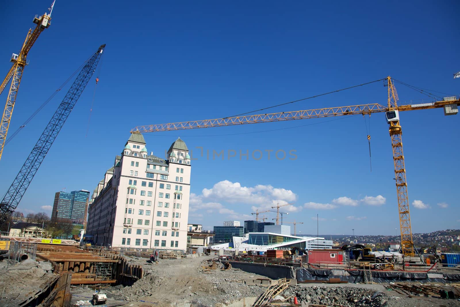 Construction in progress in Oslo, Noway. In the background we see the famous Opera house, as well as the new buildings called "barcode" being constructed. Illustrating a city on the rise, under construction.