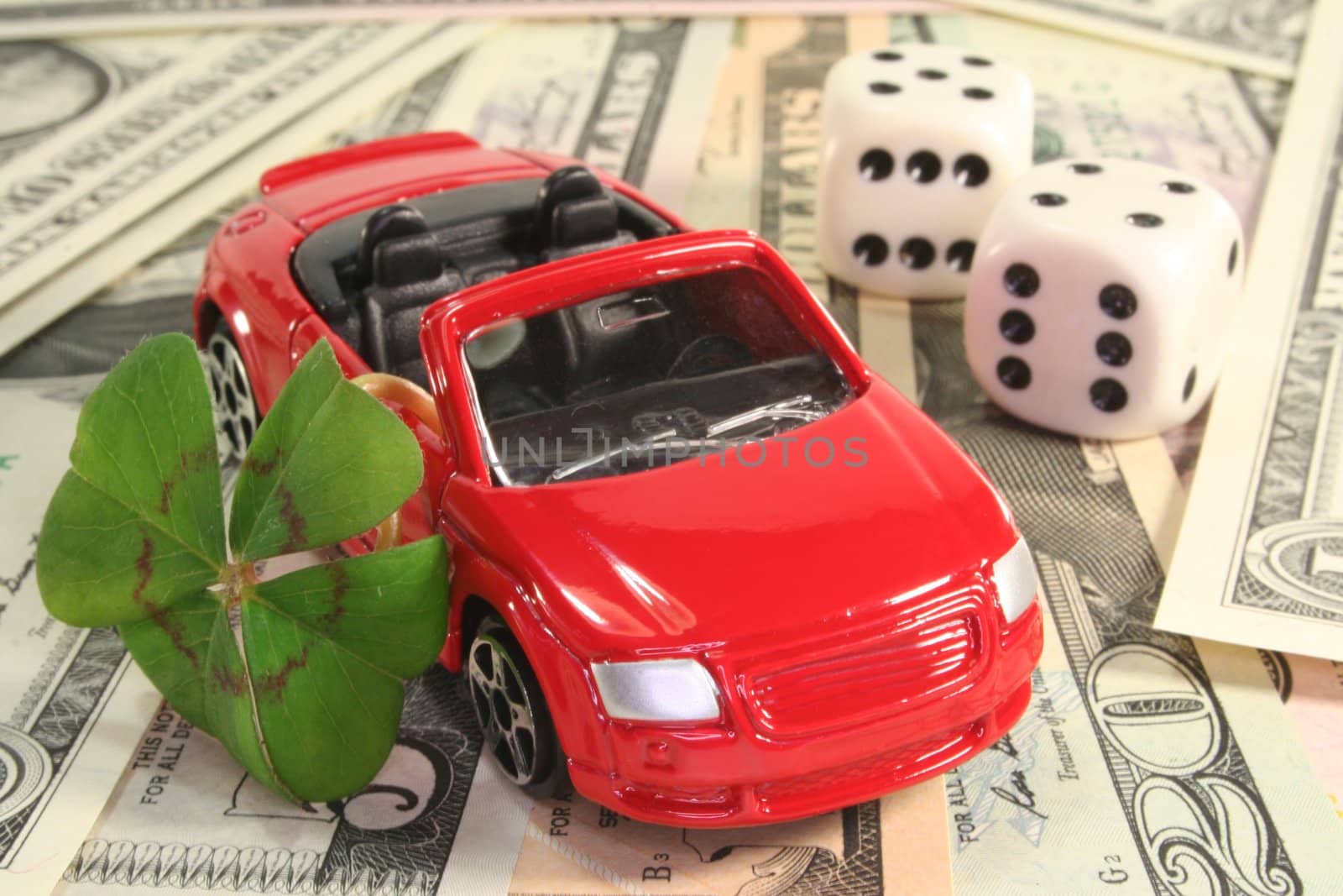 red car with lucky clover, dice and dollar notes