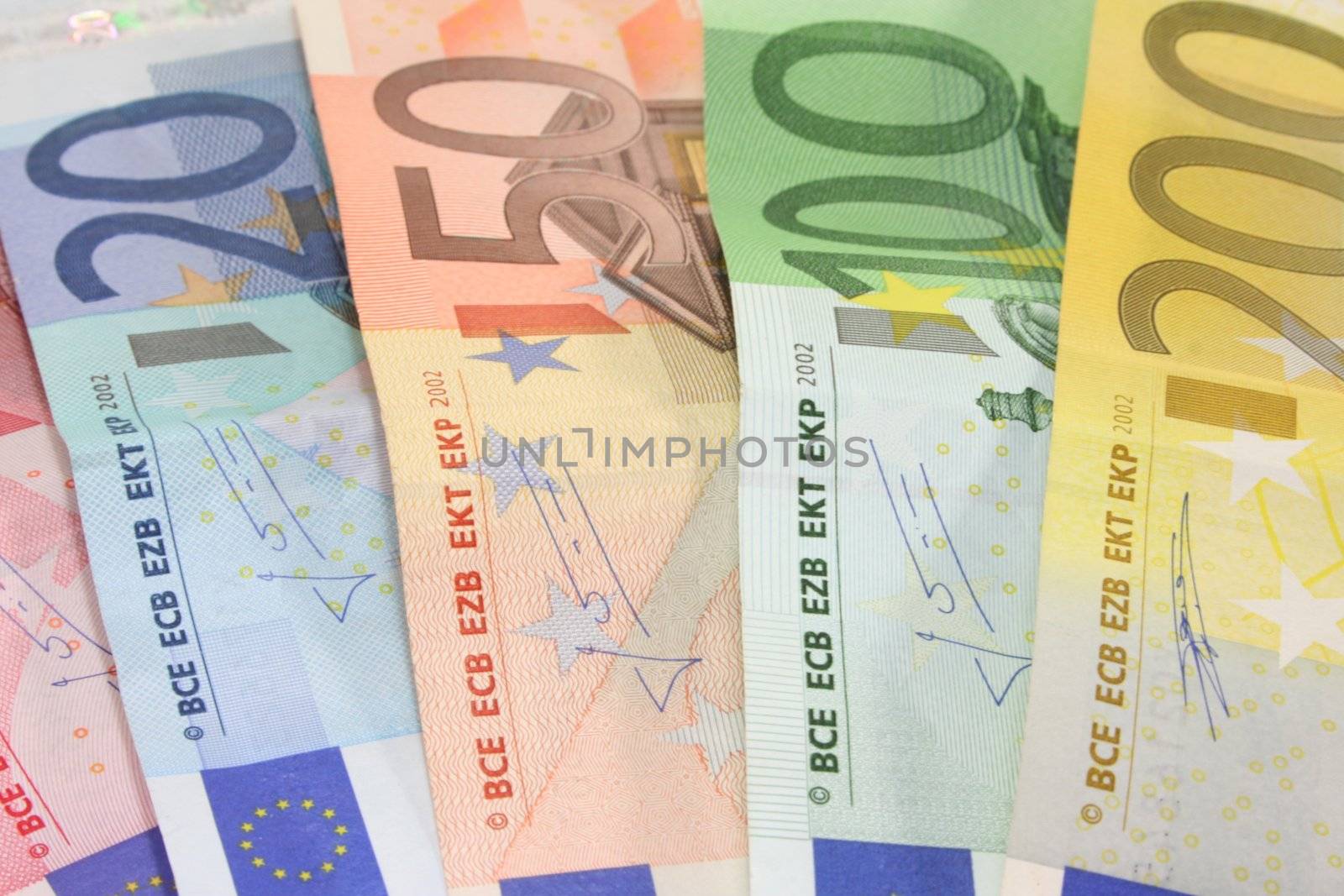 a big pile of euro notes on a white background