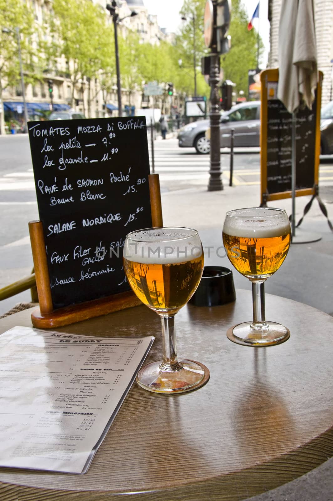 Two glasses of beer on the table of street cafes. Restaurant menu. Urban scene.