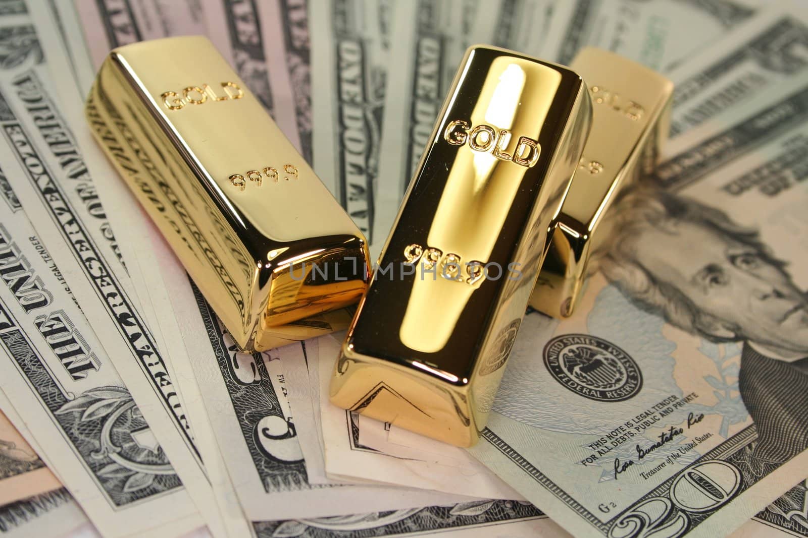 three gold bars on dollar bills by discovery