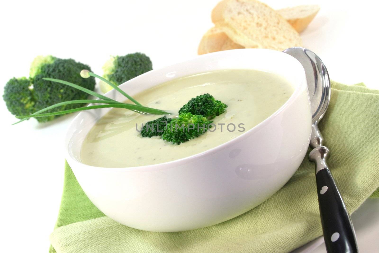 a cup of broccoli cream soup with fresh vegetables