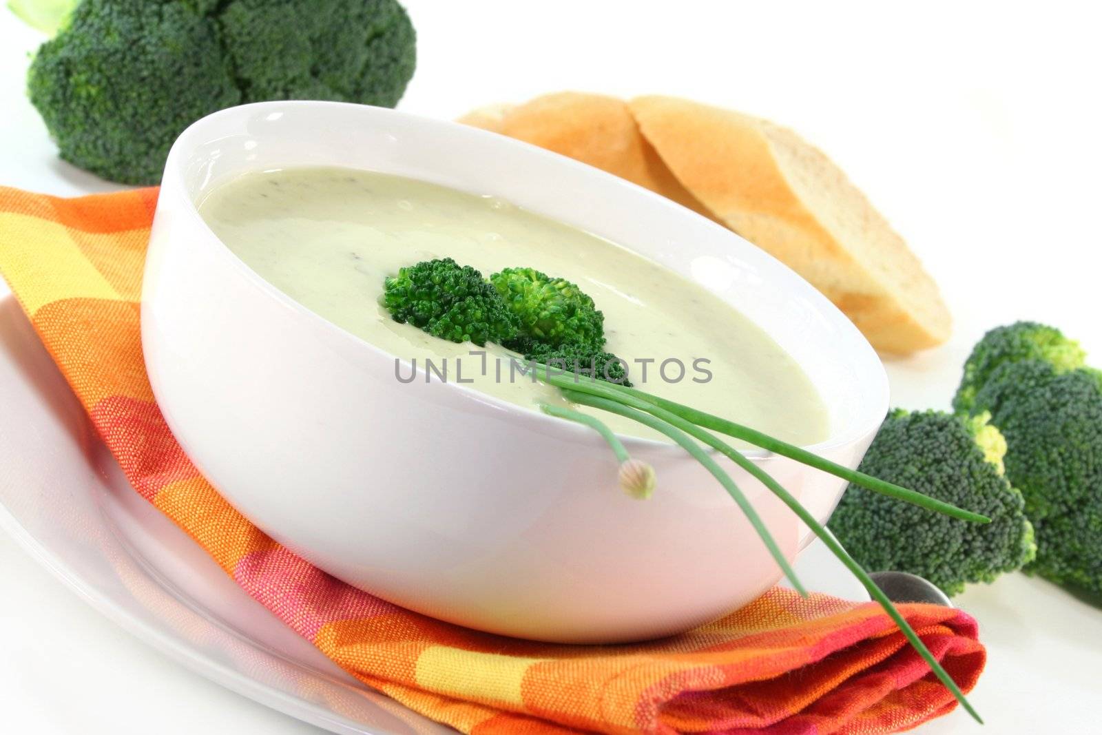 a cup of broccoli cream soup with fresh vegetables