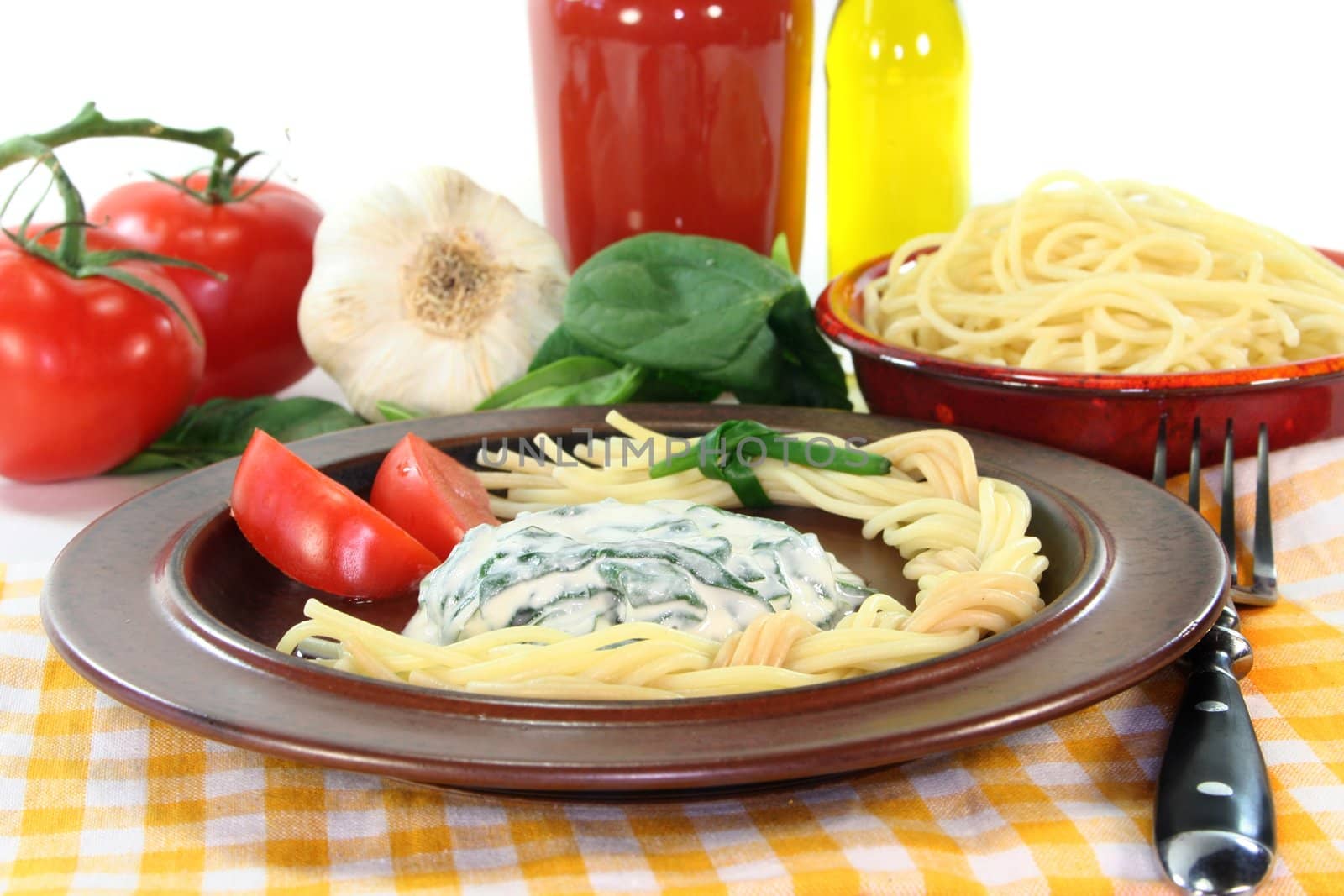 a pasta plait with spinach and cheese sauce with fresh ingredients