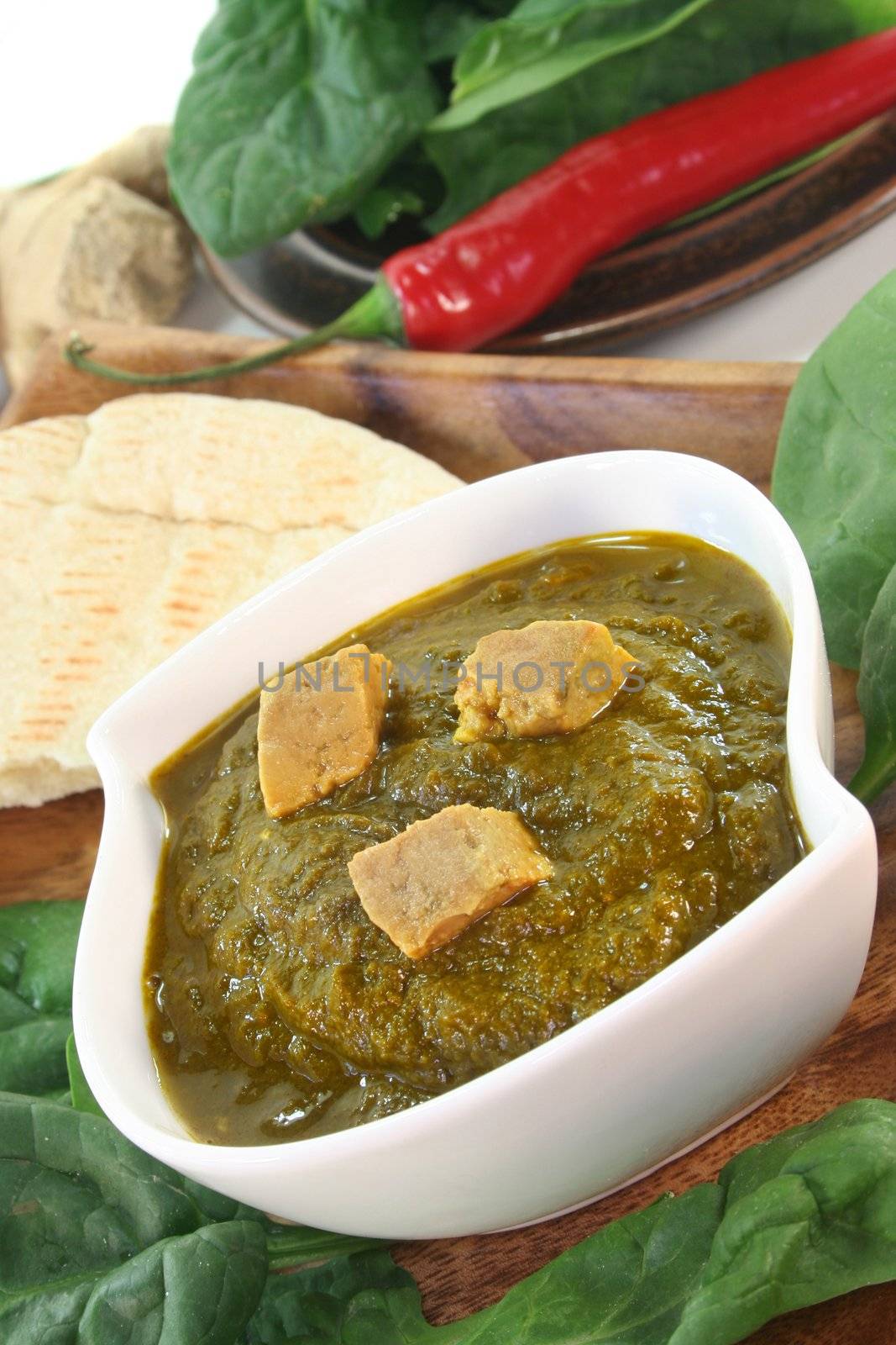 Indian Palak Paneer with rice and fresh ingredients
