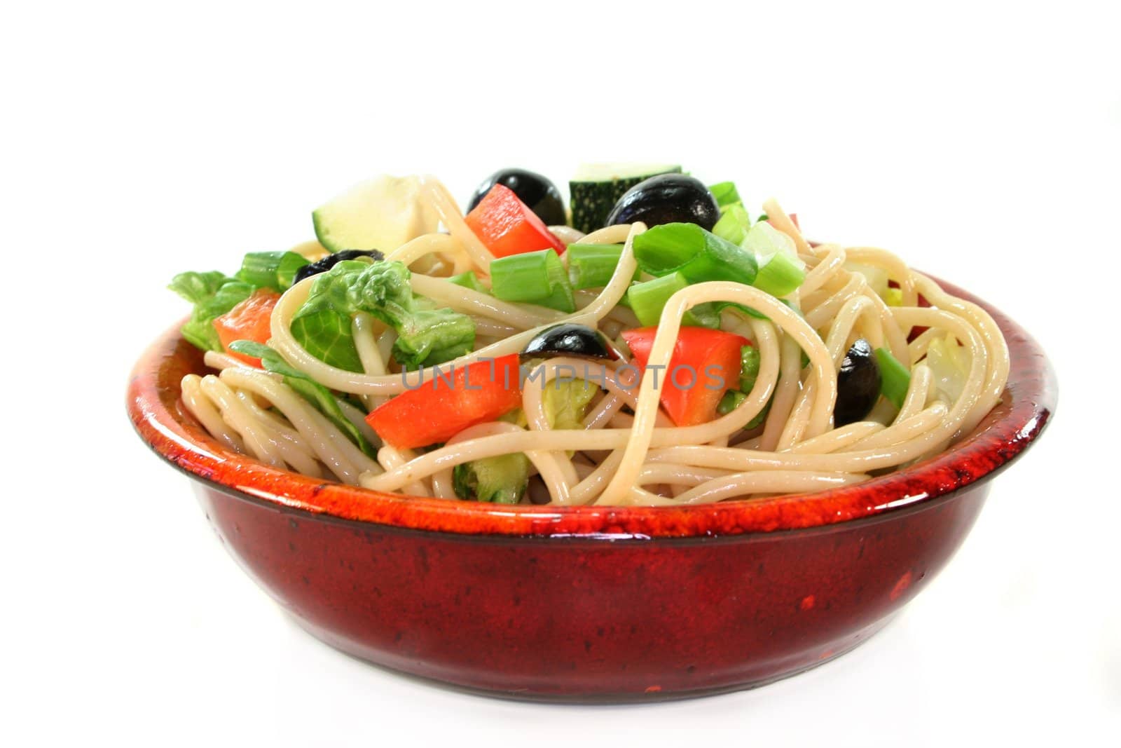 a bowl of pasta salad with spaghetti and fresh vegetables