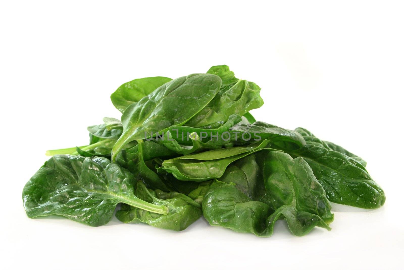 a handful of spinach on a white background
