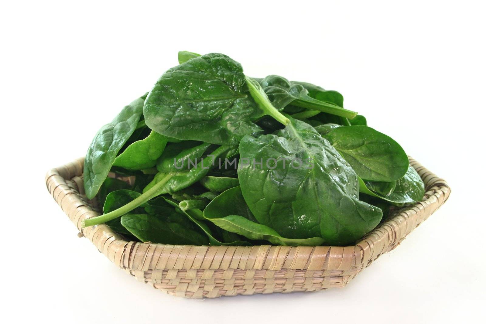 a basket filled with fresh spinach