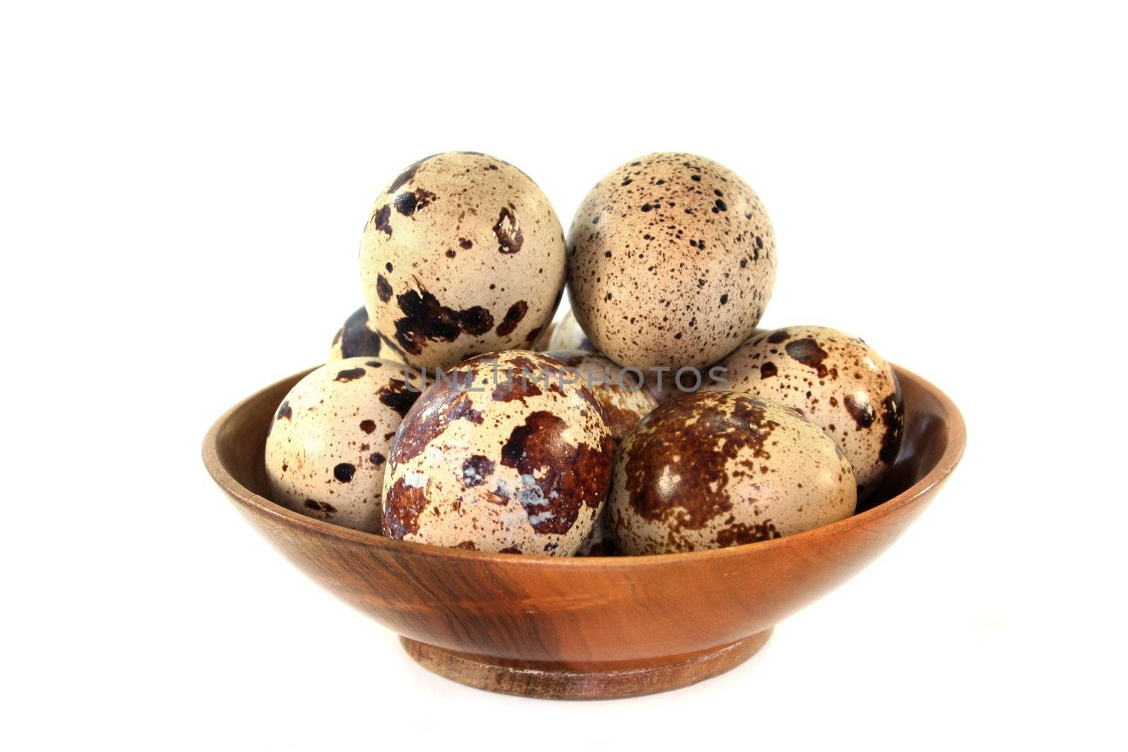 a couple of quail eggs on a white background
