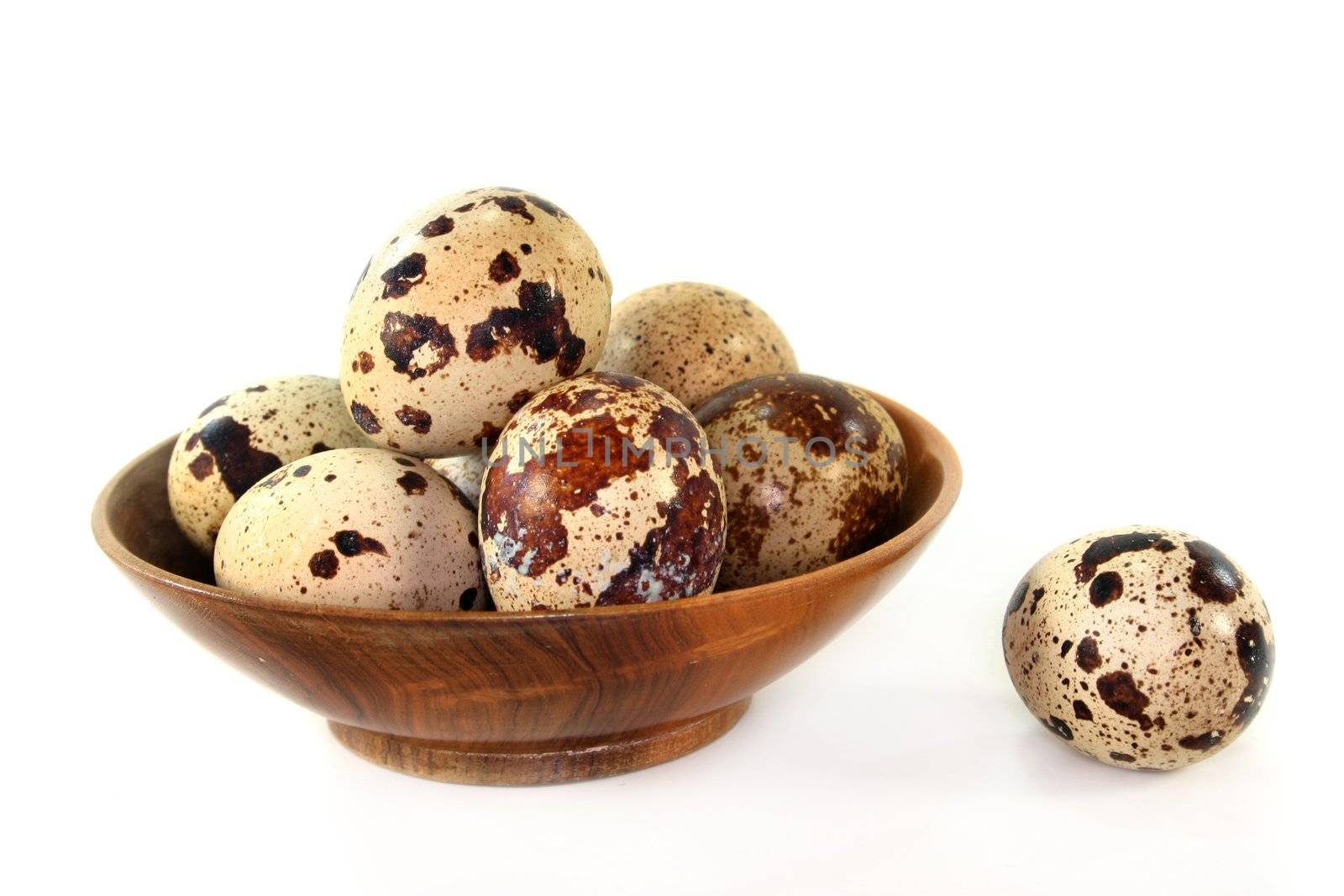 a couple of quail eggs on a white background