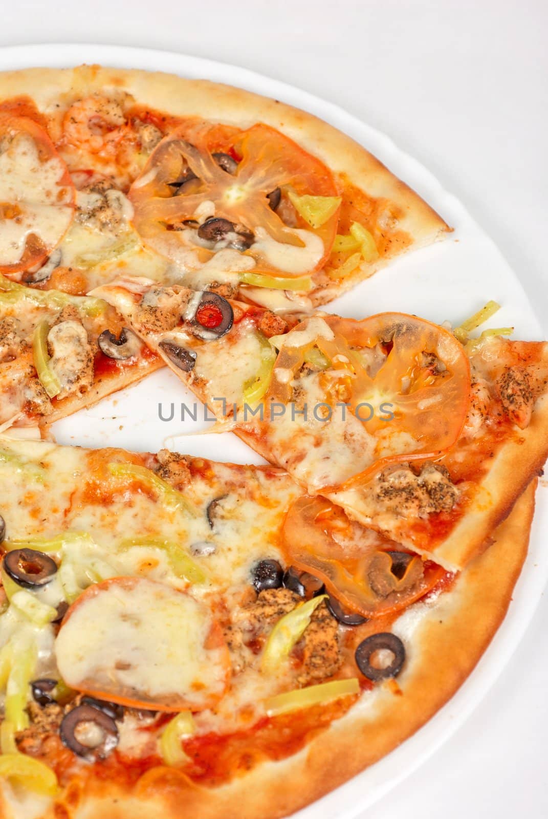 seafood pizza closeup with salmon, shrimps, tomato, pepper, olive and mozzarella cheese on a white background