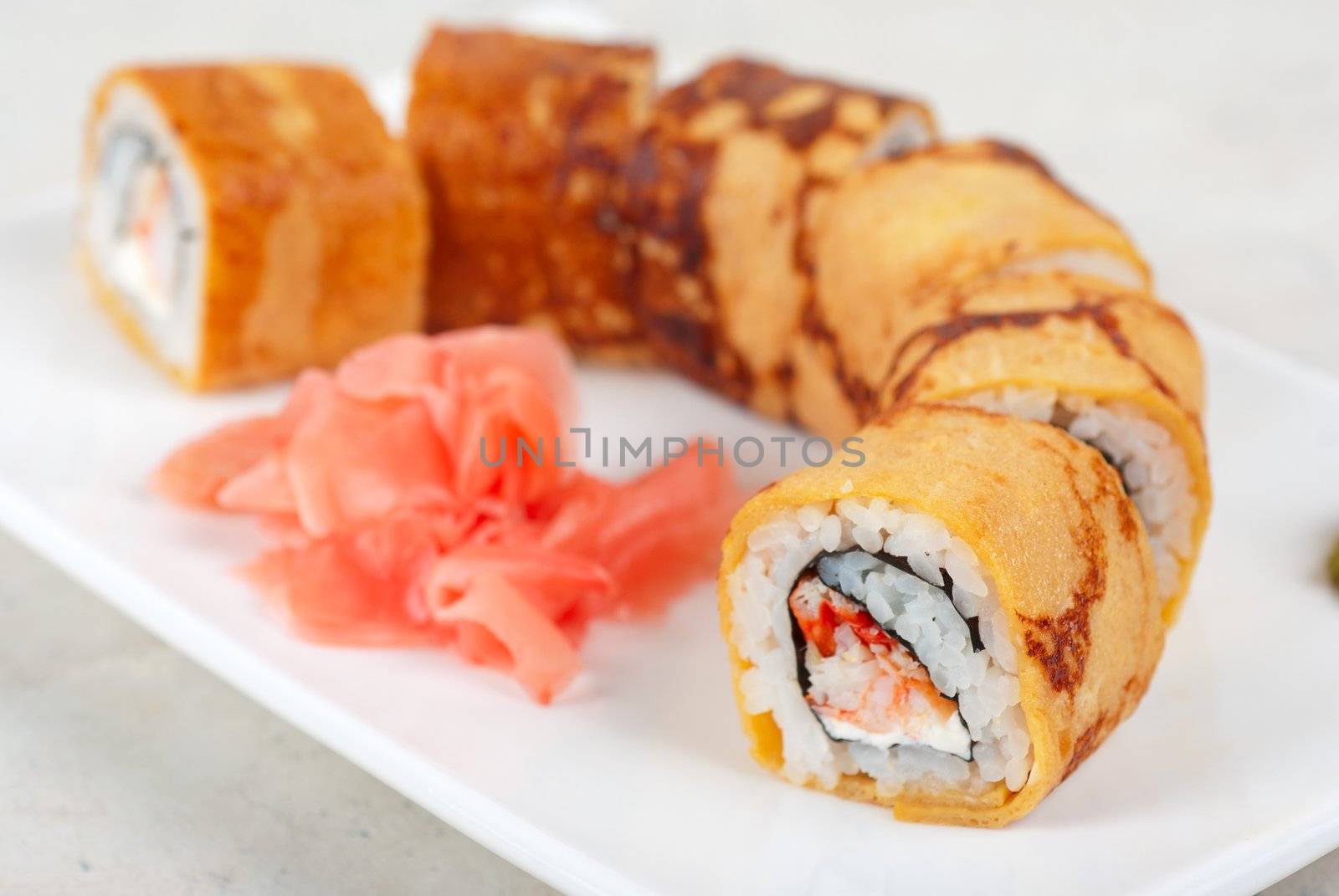 Sushi - made of crab meat, cheese, omelette outside