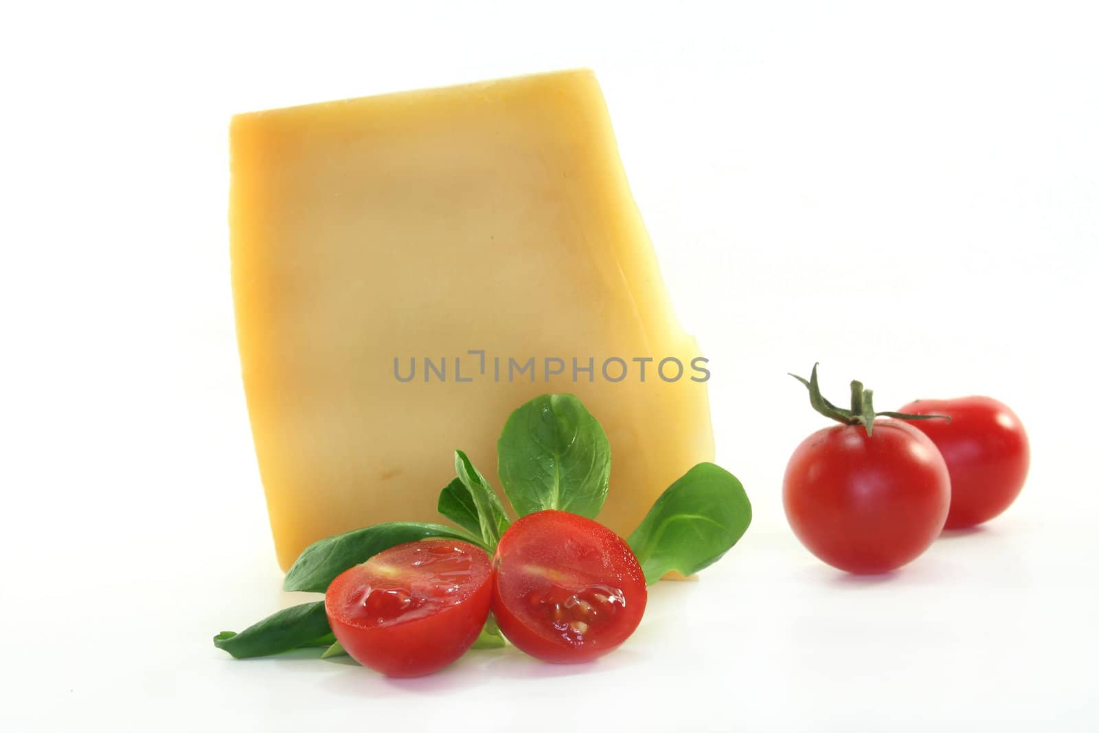 a piece of cheese with fresh tomatoes and corn salad
