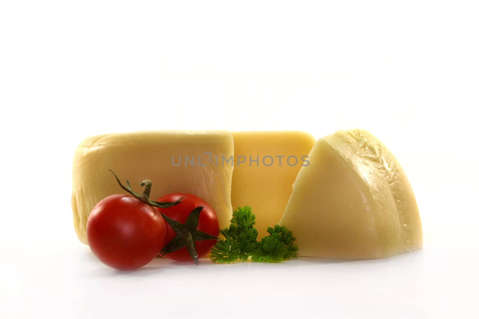 a loaf of cheese and fresh tomato on white background