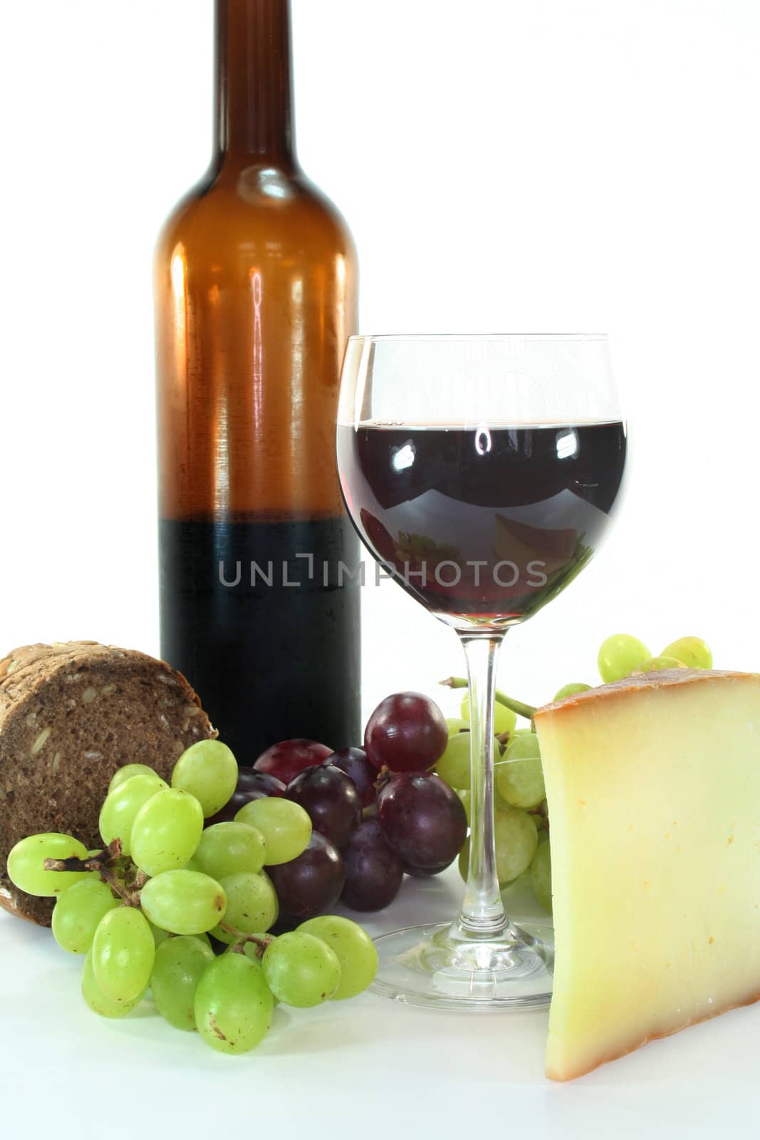 Red wine, cheese, grapes and bread on a white background
