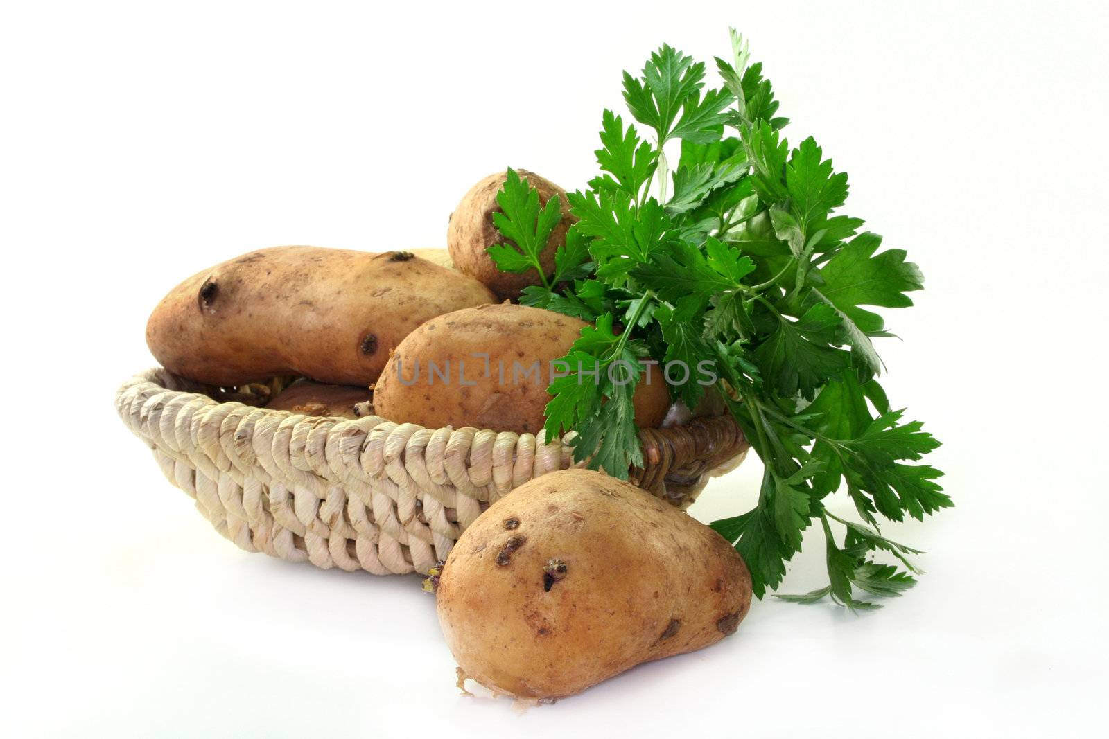 fresh potatoes in a basket on a white background