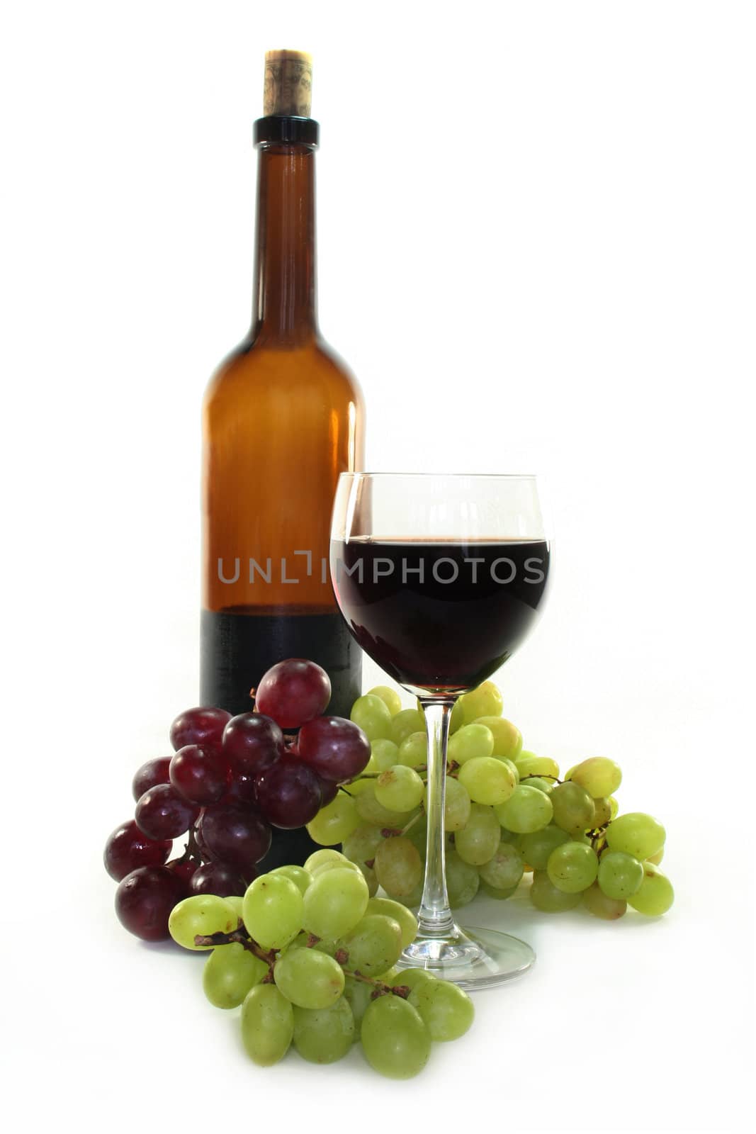 Red wine and dark and bright grapes on a white background