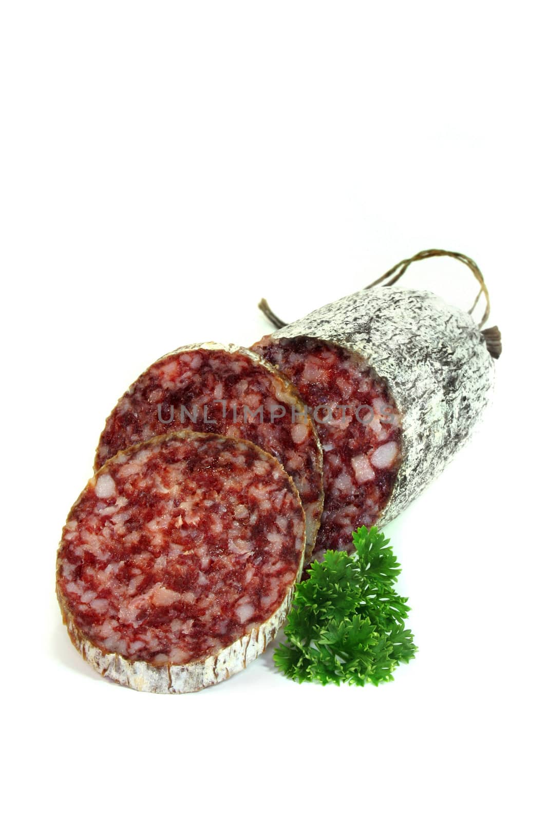 Salami and parsley on a white background