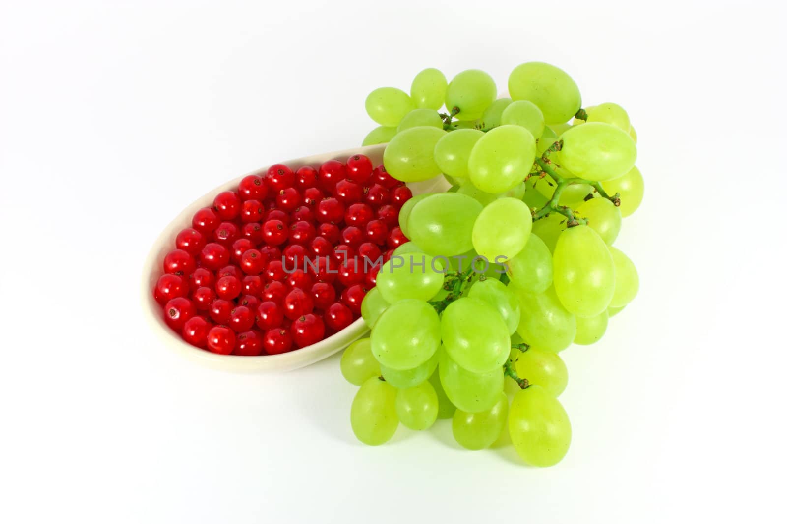 Grape and red currant isolated on white