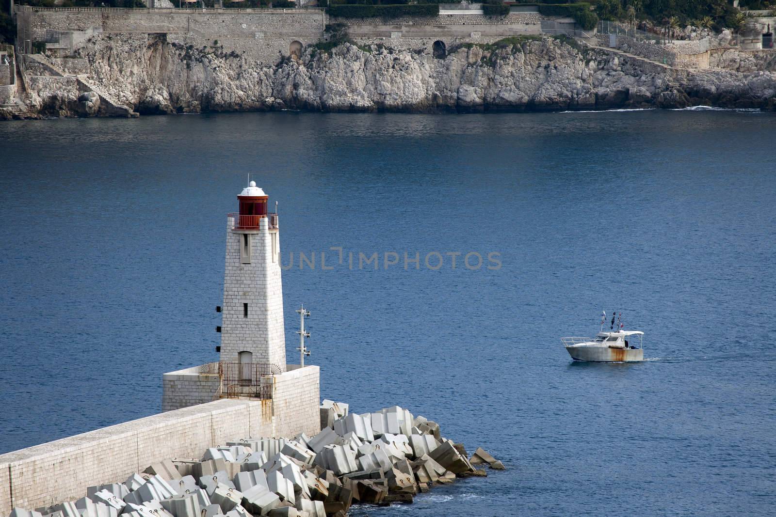 Lighthouse le phare de Nice with boat in background.