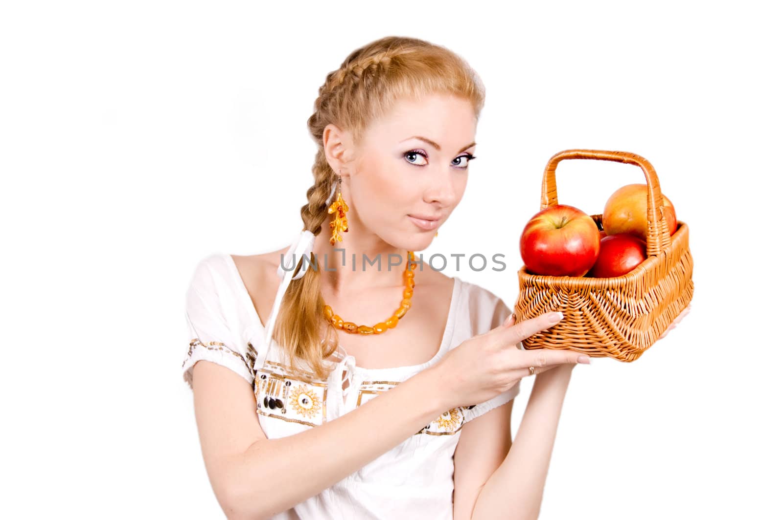 Redheaded woman holding basket of apples on white