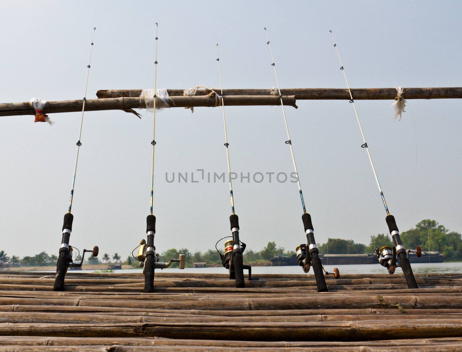 Fishing Poles on Pier with river in Background