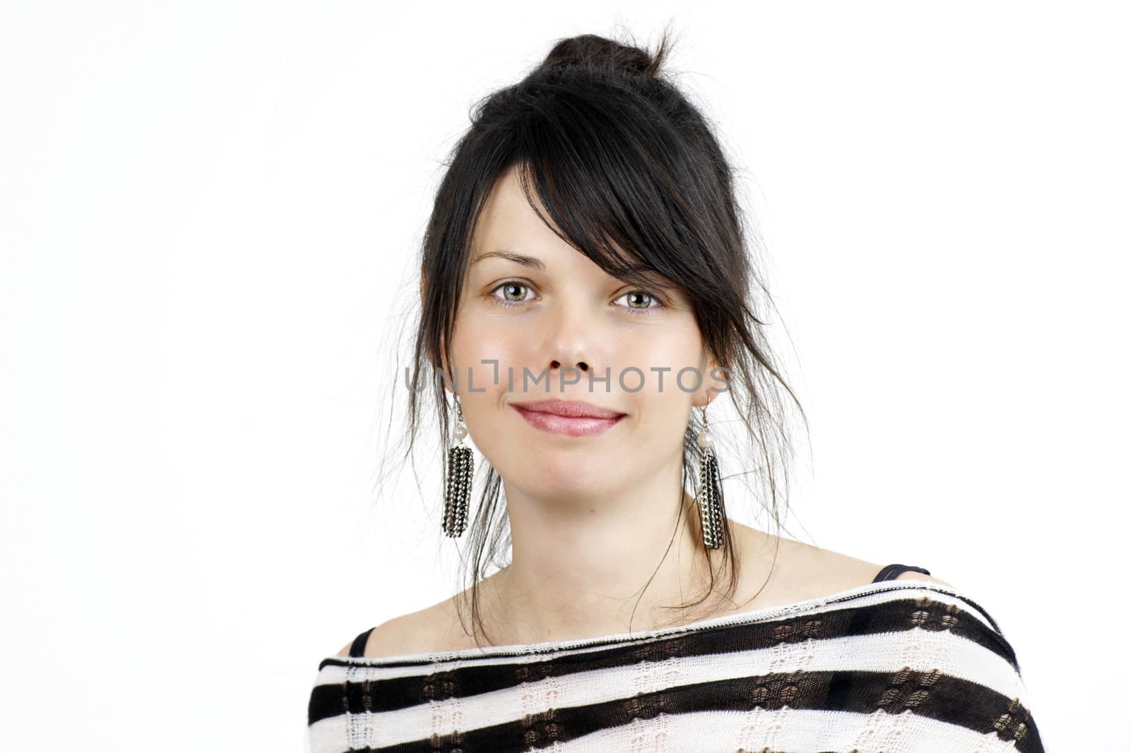 Portrait of a naturally beautiful and healthy young woman with dark hair and green eyes with hint of a smile,studio shot on white.