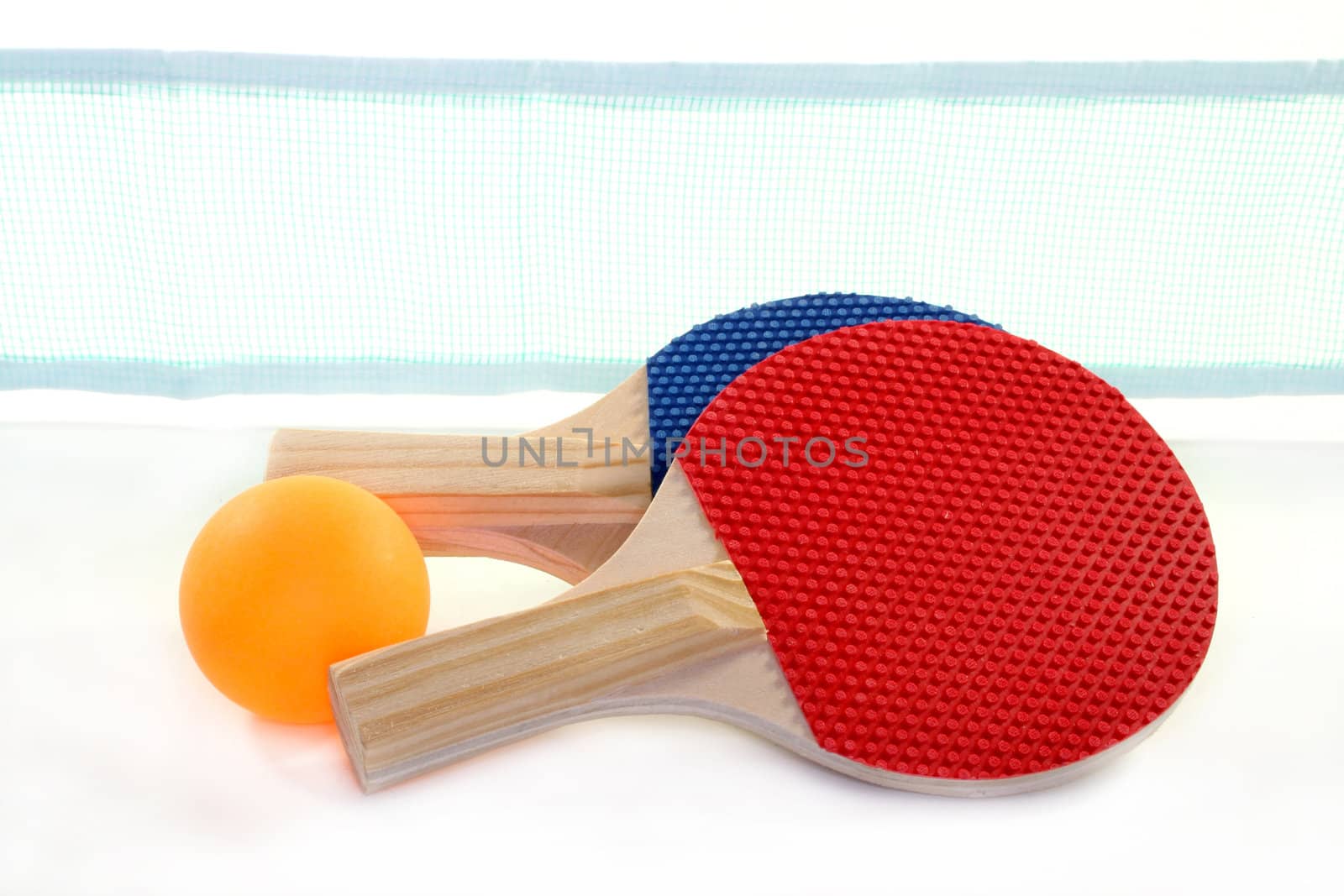 two table tennis bats, net and ball on a white background