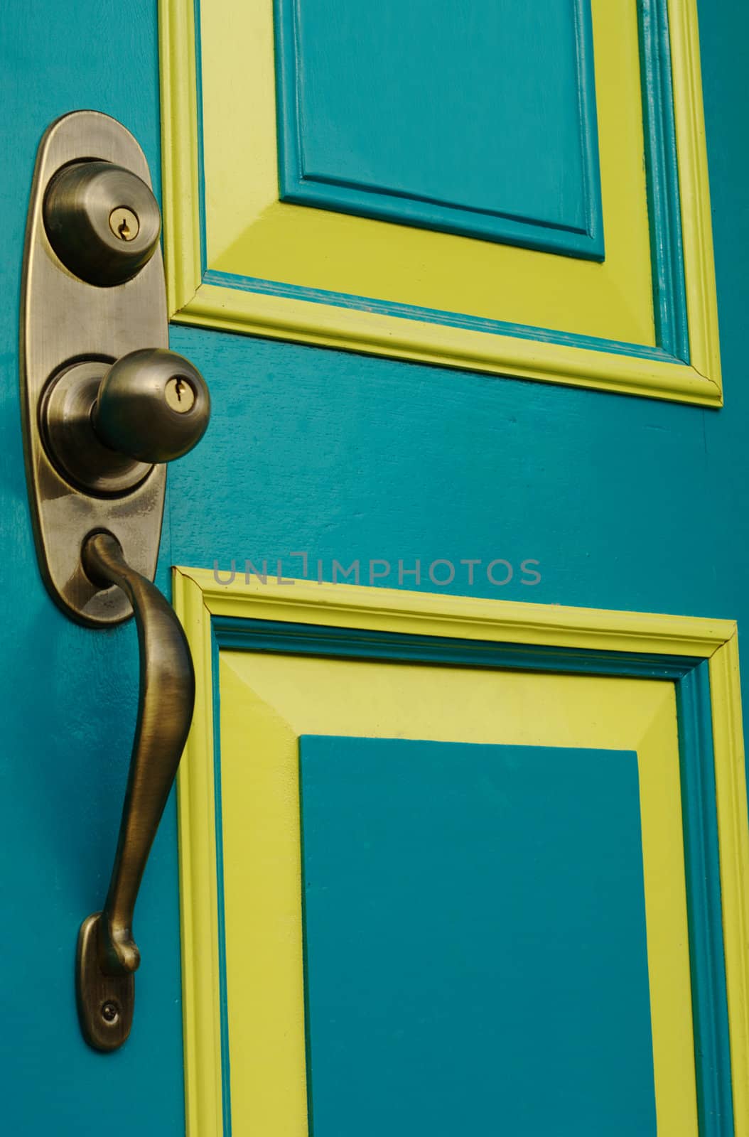 Turquoise colored door with metal doorknob and handle 