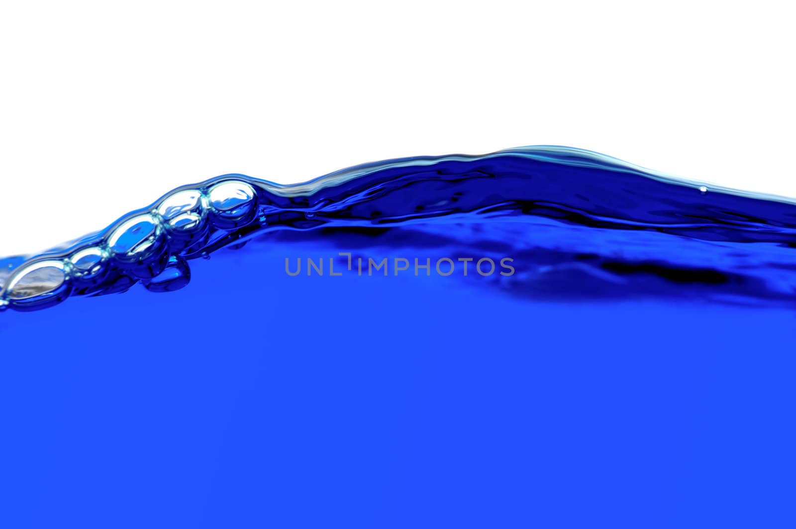 Blue water with air bubbles in the water line. Focus on the water line.