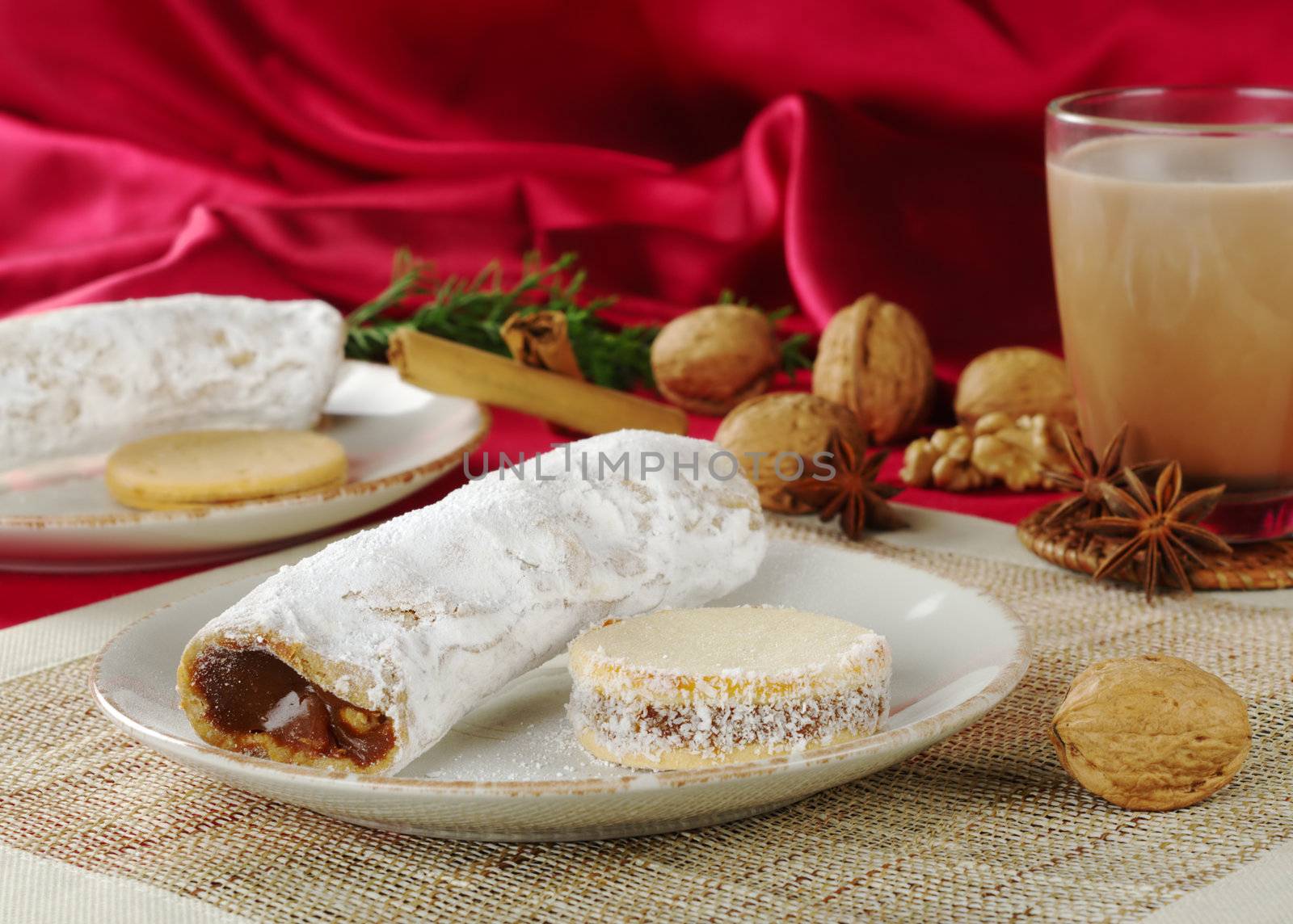 Peruvian cakes filled with a caramel-like cream called Manjar: the long one is called Guarguero, the round one is called Alfajor (Selective Focus, Focus on the front of the two cakes)