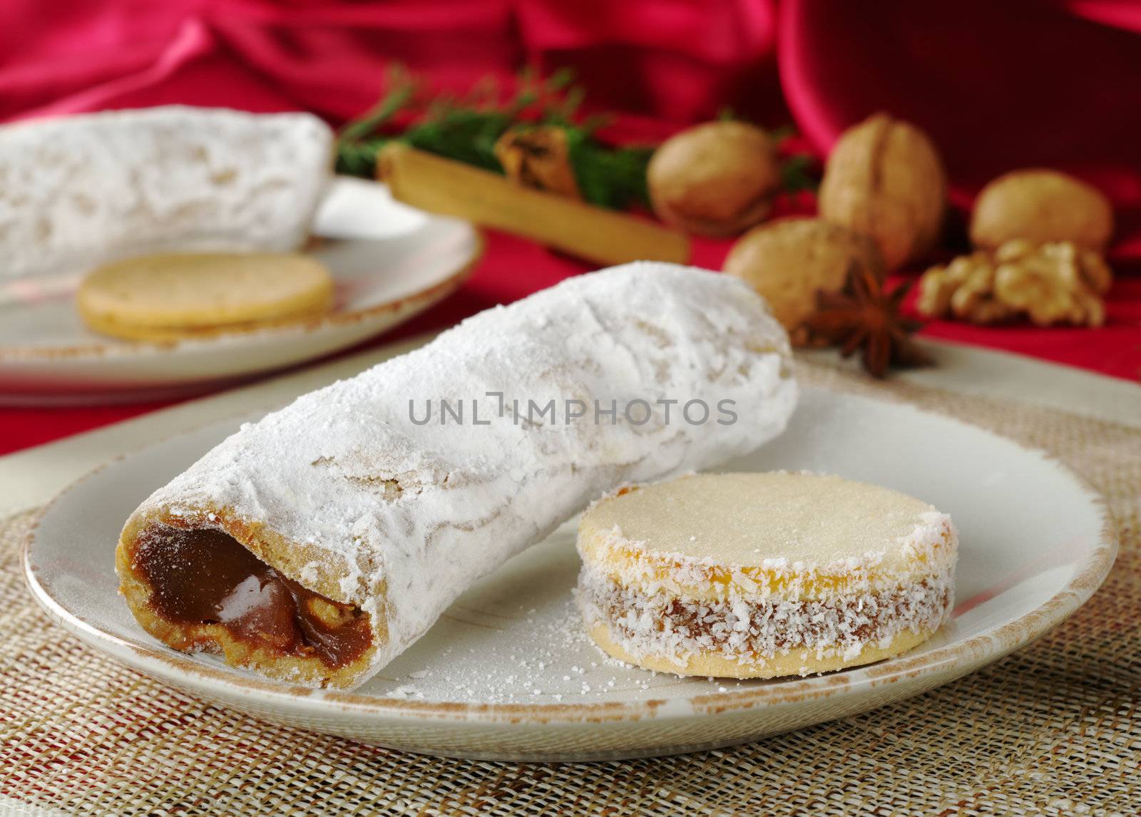 Peruvian cakes filled with a caramel-like cream called Manjar: the long one is called Guarguero, the round one is called Alfajor (Selective Focus, Focus on the front of the two cakes)