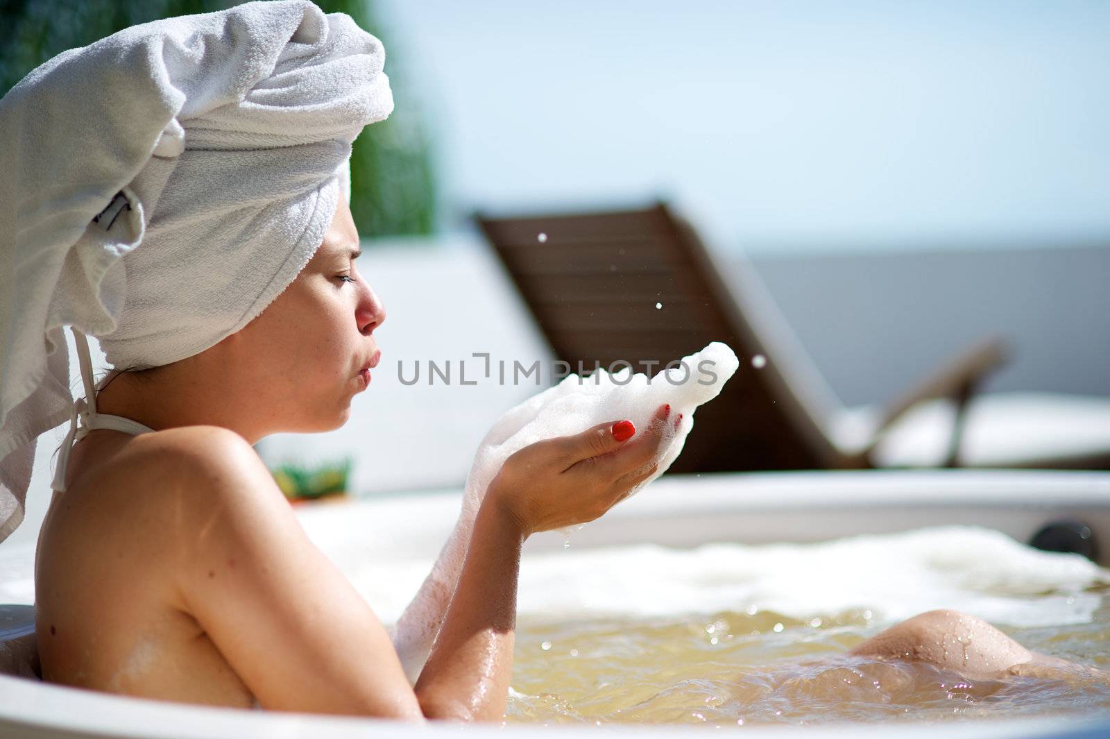 Woman relaxing in a jacuzzi in a resort in Porto Belo, Santa Catarina, Brazil