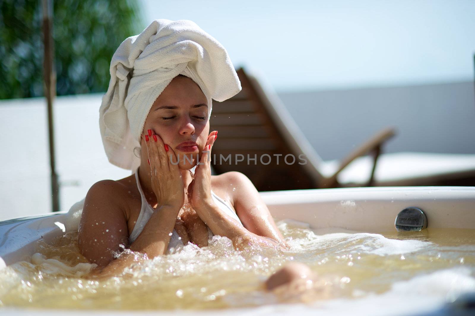 Woman relaxing in a jacuzzi in a resort in Porto Belo, Santa Catarina, Brazil by swimnews