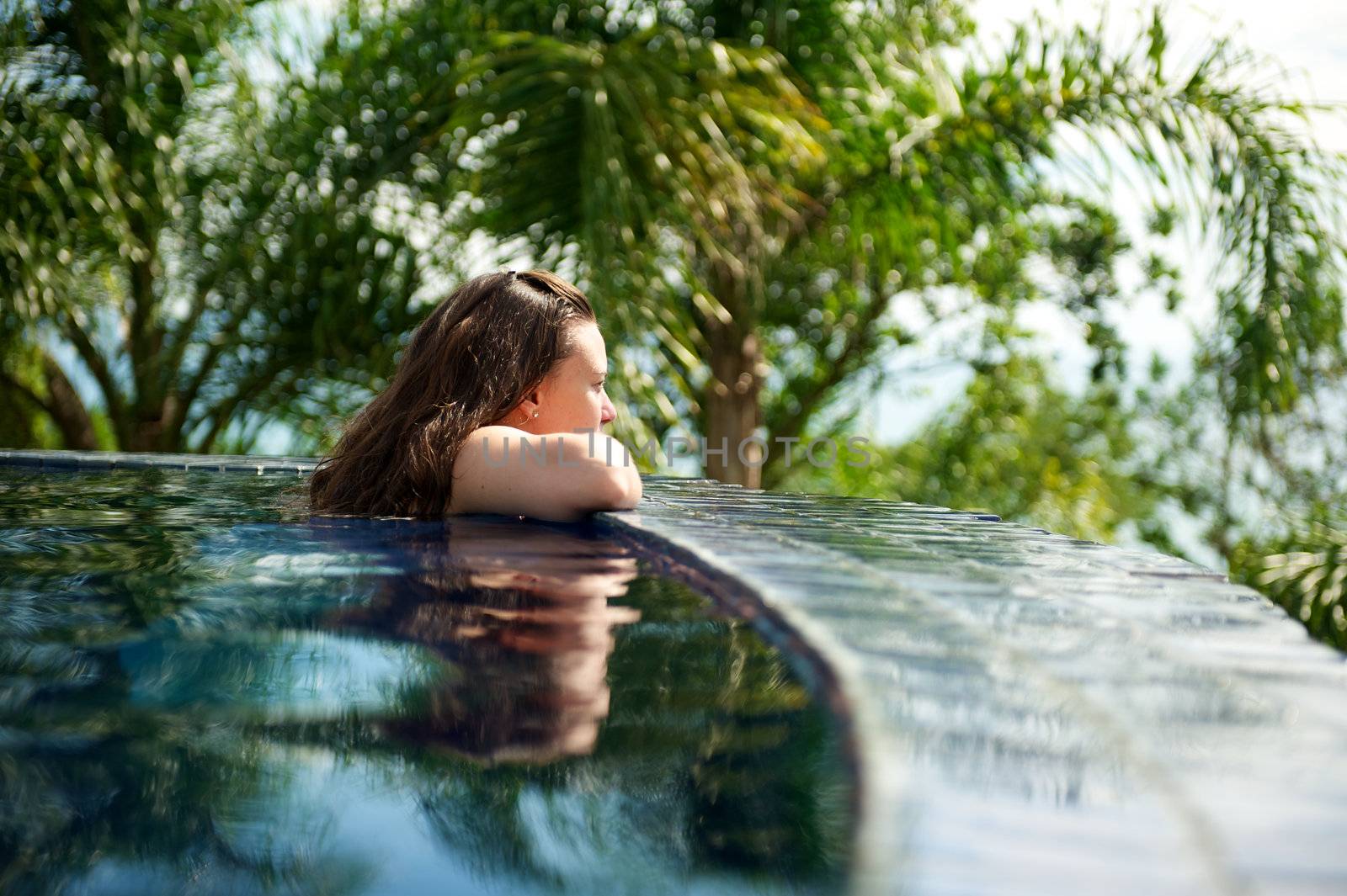 Woman relaxing in a paradise swimming pool in a resort in Porto Belo, Santa Catarina, Brazil