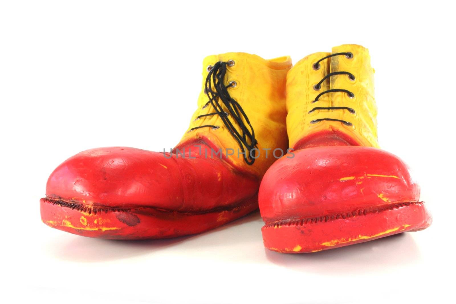 red and yellow clown shoes on a white background