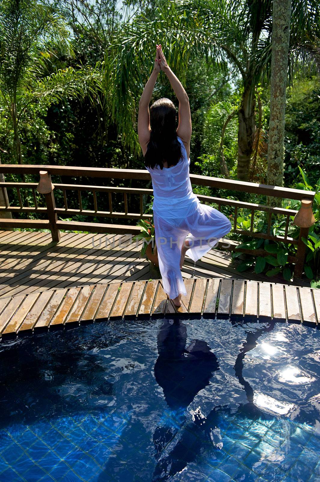 Woman relaxing in a paradise swimming pool in a resort in Porto Belo, Santa Catarina, Brazil