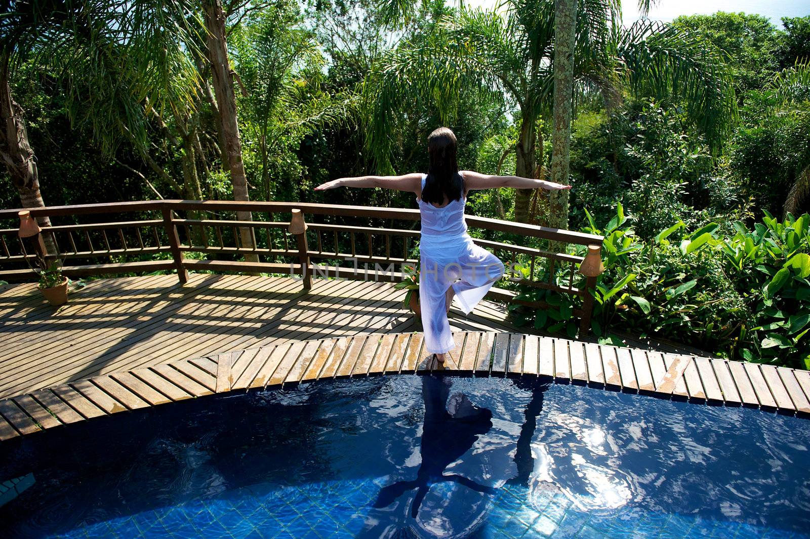 Woman relaxing in a paradise swimming pool in a resort in Porto Belo, Santa Catarina, Brazil