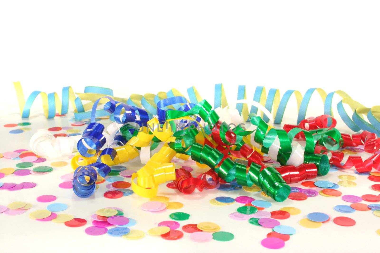 Colorful confetti and streamers on a white background
