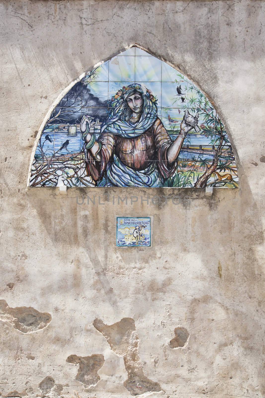 Holy painting on the wall, building facade in orbetello, Italy.